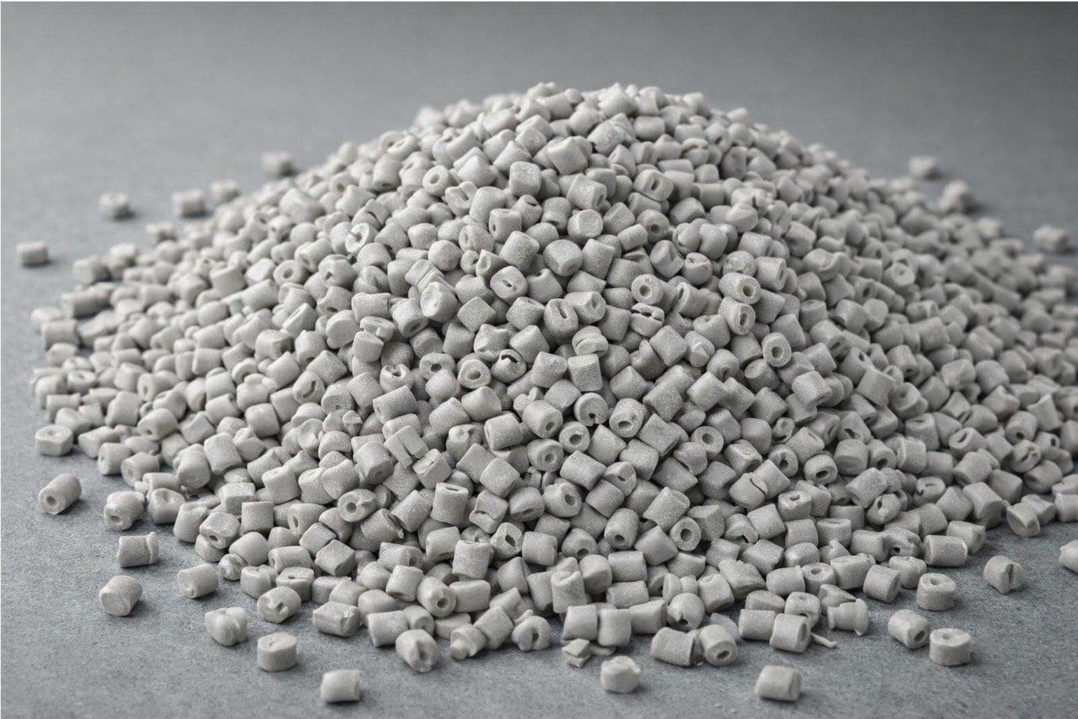 Pile of grey engineering resin pellets